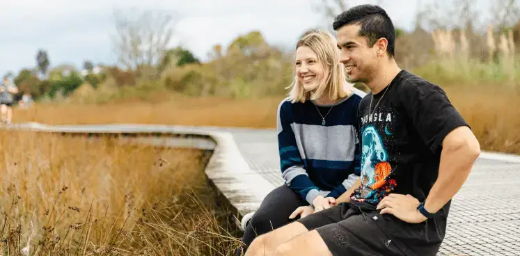 Happy couple sitting on a path