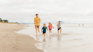 Family running on the beach