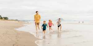 Family running on the beach